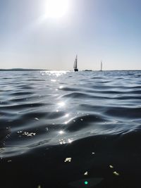 Sailboat sailing on sea against sky