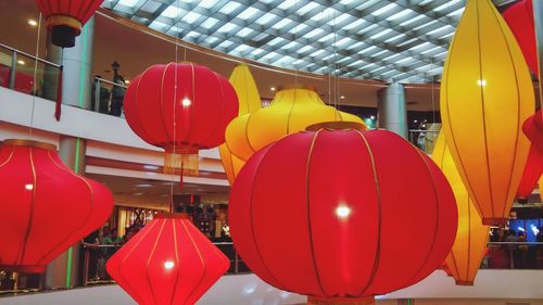 Red balloons against built structure