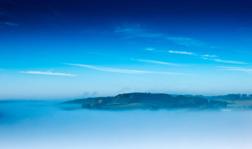 Scenic view of sea against blue sky