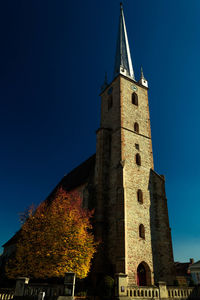 Low angle view of historic building against clear blue sky