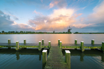 Autumn shower over a lake with pier in holland