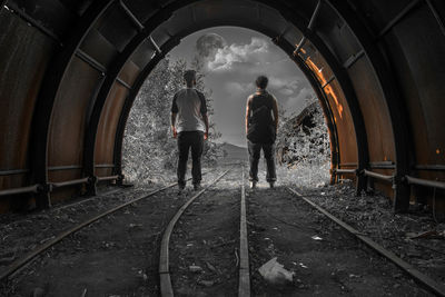 Rear view of people standing in train