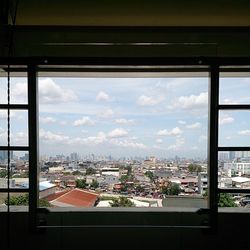 Cityscape against cloudy sky