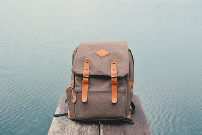 Close-up of backpack against sea