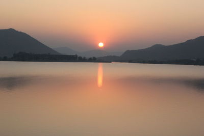 Scenic view of silhouette mountains against clear sky during sunset