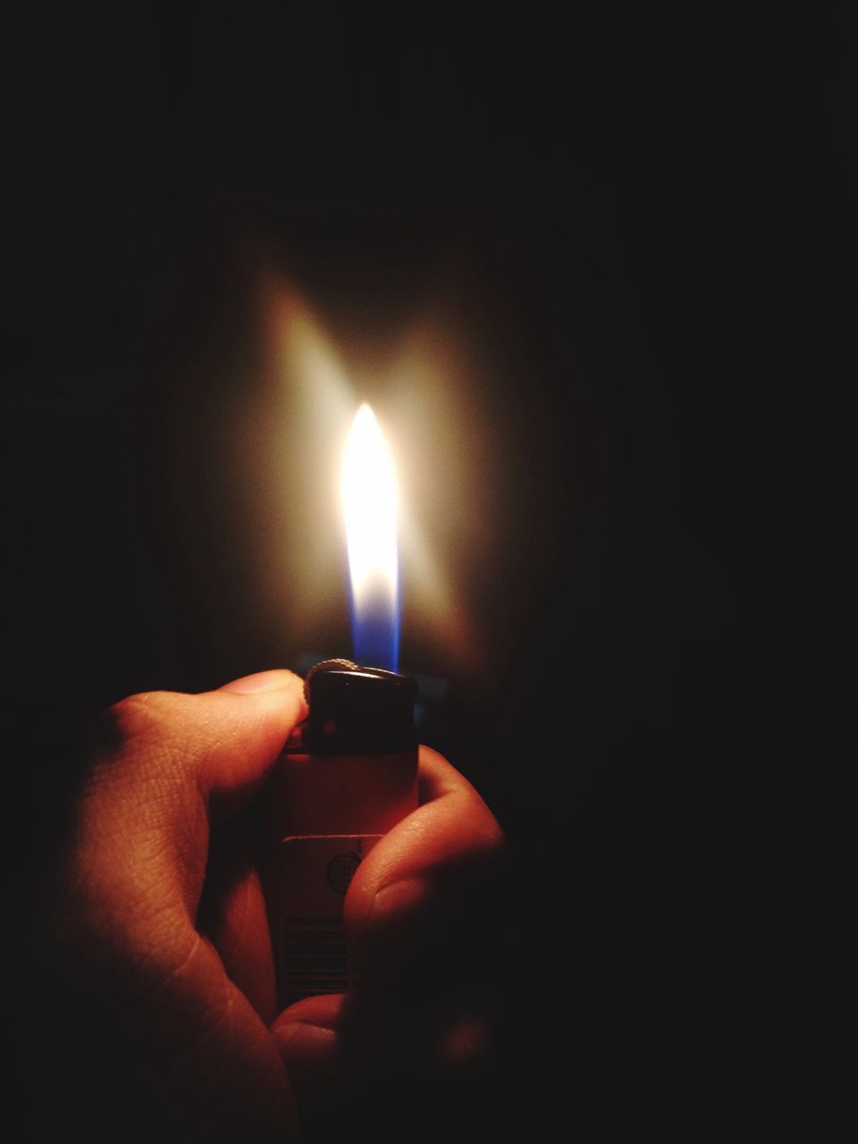 fire - natural phenomenon, flame, burning, human hand, heat - temperature, holding, human body part, one person, cigarette lighter, night, glowing, human finger, real people, illuminated, darkroom, close-up, indoors, black background, lifestyles, people