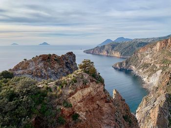 Panoramic view of sea and mountains against sky