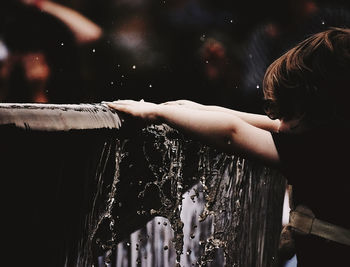 Rear view of child playing in water