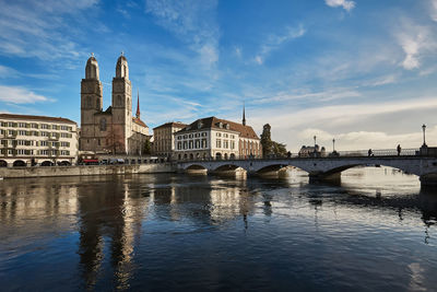 Bridge over river with buildings in background