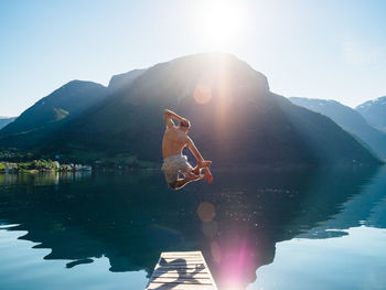 High angle view of shirtless man swimming in lake