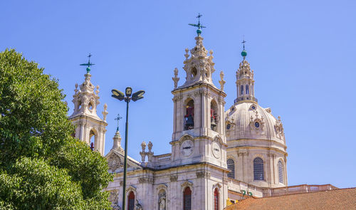 Low angle view of historic building against clear blue sky