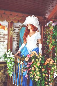 Thoughtful bride standing in decorated balcony