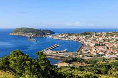 High angle view of sea and buildings against sky