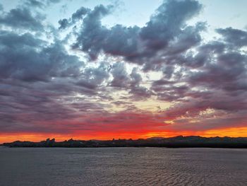 Scenic view of dramatic sky over sea during sunset