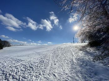 Snow covered land against sky