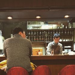 Rear view of man sitting in restaurant