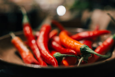 Close-up of red chili peppers on table