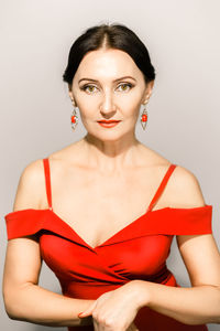 Portrait of young woman against white background