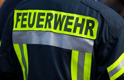 Rear view of firefighter wearing uniform