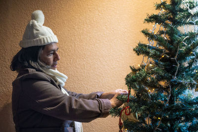 Side view of man wearing christmas tree