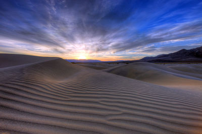 Scenic view of desert against sky during sunset