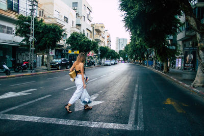 Man walking on road in city