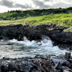 Scenic view of river against cloudy sky