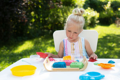 Cute girl sitting on table