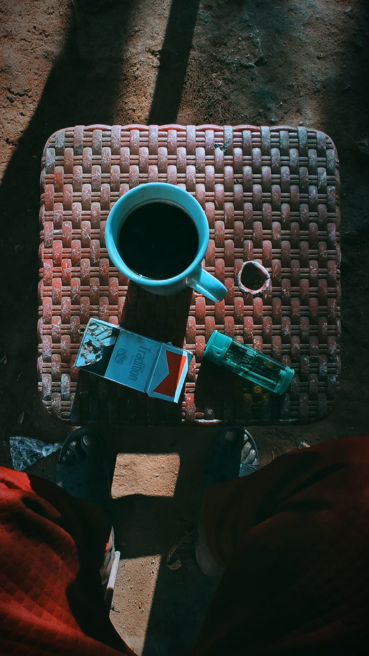 blue, drink, red, black, cup, food and drink, refreshment, coffee, coffee cup, mug, one person, high angle view, adult, darkness, men, holding, sitting, hot drink, leisure activity, table, lifestyles