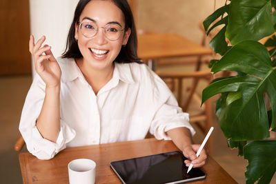 Portrait of young woman using mobile phone