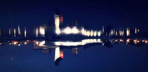 Reflection of illuminated buildings in water at night