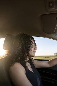 Portrait of smiling young woman in car