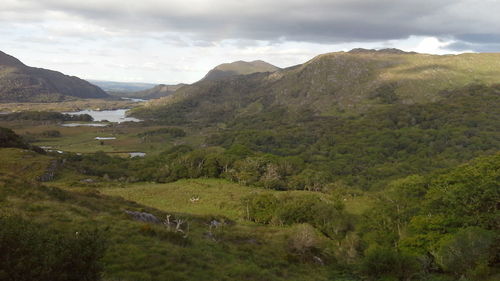 Scenic view of mountains against cloudy sky