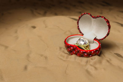 High angle view of heart shape on sand