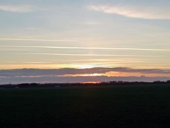 Scenic view of field against sky during sunset