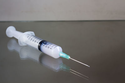 Close-up of syringe on table