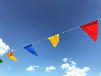 Low angle view of flags against sky