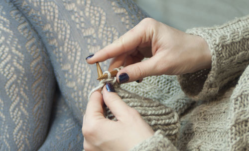 High angle view of woman knitting wool