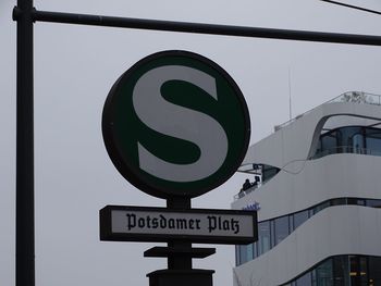 Low angle view of road sign against sky