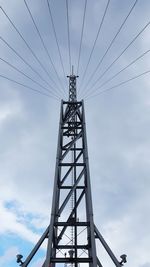 Low angle view of electricity pylon against sky