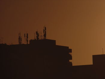 Silhouette of building against sky during sunset