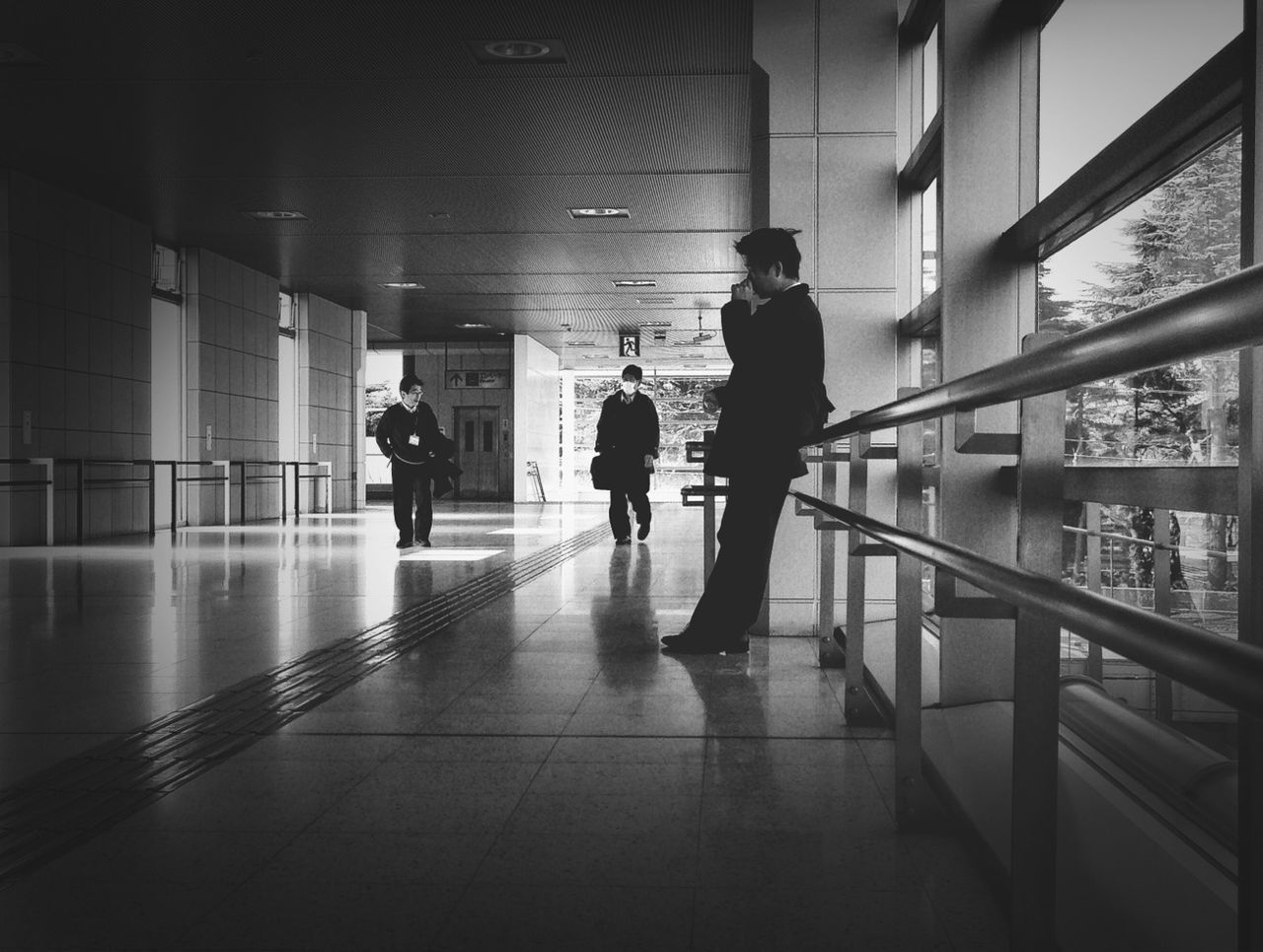 indoors, architecture, walking, lifestyles, built structure, men, full length, corridor, person, reflection, flooring, rear view, leisure activity, ceiling, tiled floor, silhouette, building, modern