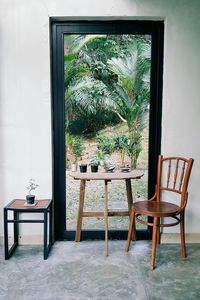 Chair and table by glass door at home