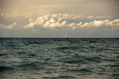 Sailboat in sea against sky