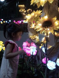 High angle view of girl with pink flowers