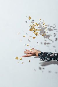 Close-up of hand throwing confetti