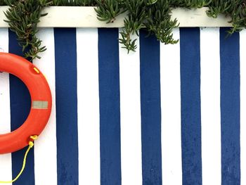 Lifeguard ring on striped fence