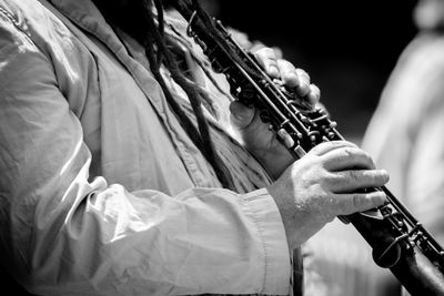 Close-up of man playing clarinet