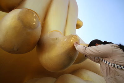 Low angle view of man against clear sky