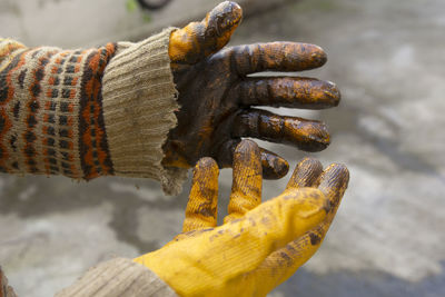 Close-up of hand holding rusty metal